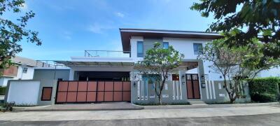 Modern house exterior with garage and greenery