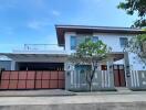 Modern house exterior with garage and greenery