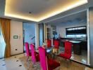 Modern dining area with red chairs and glass table