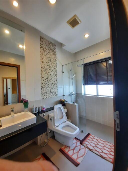 Modern bathroom with shower, sink, and toilet