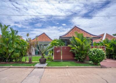 Exterior view of the property with a garden and driveway