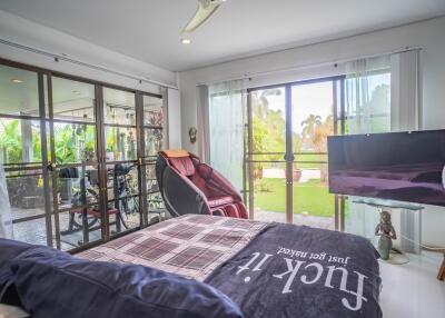 Spacious bedroom with glass sliding doors and garden view