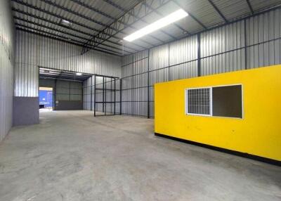 Spacious warehouse interior with high ceilings and office space