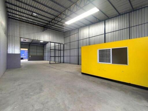 Spacious warehouse interior with high ceilings and office space