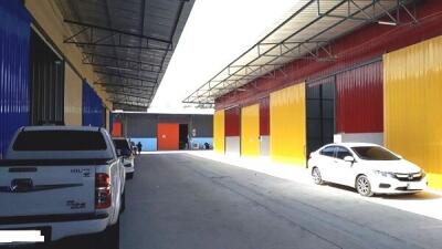 Warehouse with parked cars and colorful exterior walls