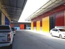 Warehouse with parked cars and colorful exterior walls