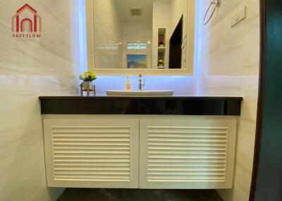 Modern bathroom with illuminated mirror and vanity