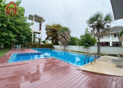 Outdoor swimming pool with adjacent wooden deck