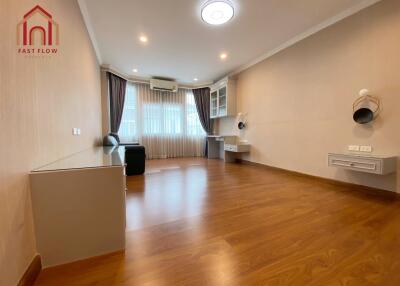 Spacious living room with wooden flooring and modern lighting