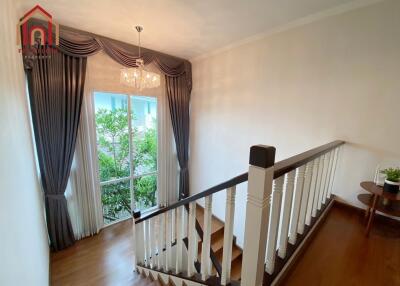 staircase area with window and chandelier