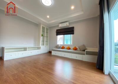 Spacious living room with wooden flooring and built-in storage