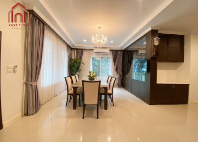 Spacious dining area with chandelier and large windows