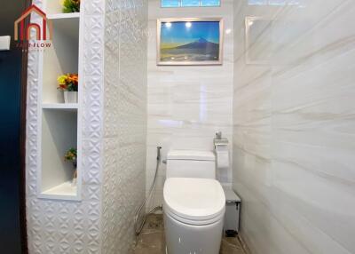 Modern bathroom with white fixtures and decorative tiles