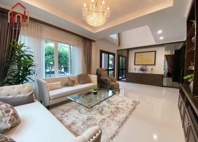 Elegant living room with a chandelier and large windows