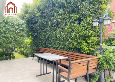 Spacious outdoor seating area with lush greenery