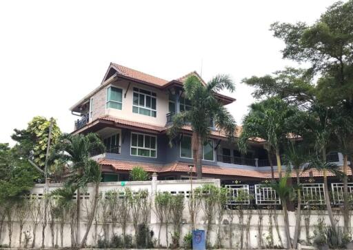 Exterior view of a multi-story house with a well-maintained garden