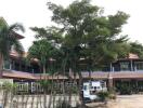 Front view of a residential building with trees