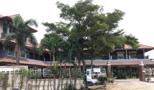 Front view of a residential building with trees