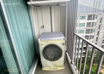 Outdoor air conditioning unit and covered washing machine area on a balcony