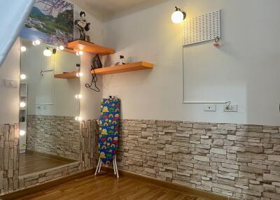 Bedroom with decorative wall elements and large mirror