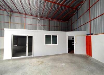 Interior view of a warehouse with an office space