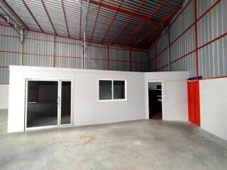 Interior view of a warehouse with an office space