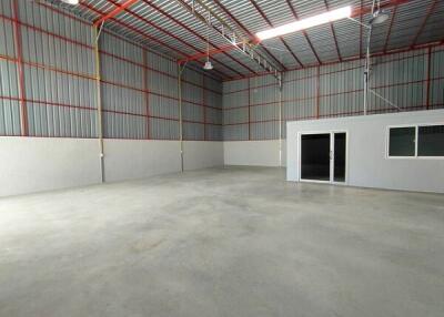 Spacious industrial warehouse with high ceiling and office space