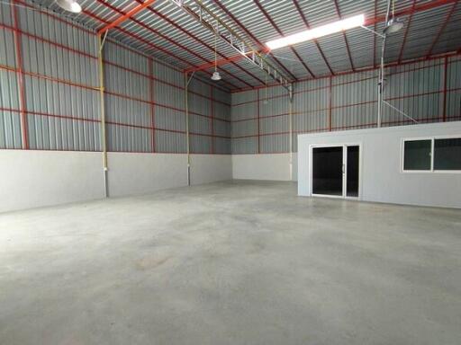 Spacious industrial warehouse with high ceiling and office space