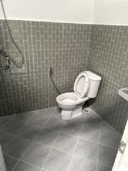 Bathroom with toilet and tiled walls