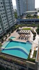 Aerial view of a residential building with a swimming pool area