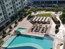 Aerial view of a residential building with a swimming pool area