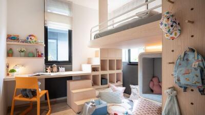 Cozy bedroom with a loft bed and study area