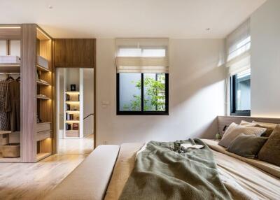 Modern bedroom with natural light and organized closet space