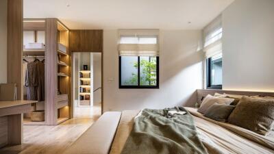 Modern bedroom with natural light and organized closet space