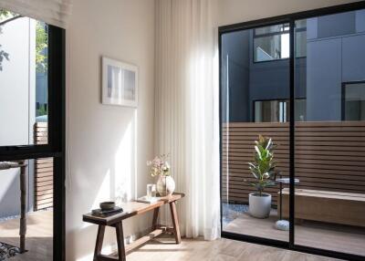 Modern living room with large windows looking out to a private patio