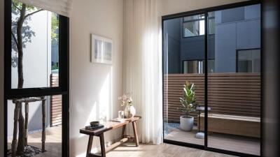 Modern living room with large windows looking out to a private patio