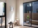 Modern living room with large windows looking out to a private patio