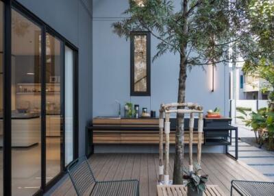 Modern outdoor patio with seating and greenery