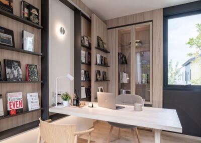 Modern home office with wooden desk and built-in bookshelves