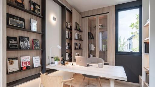 Modern home office with wooden desk and built-in bookshelves