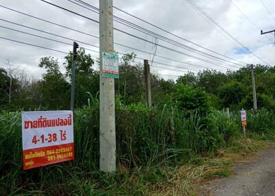 Vacant land with prominent signage and utility poles