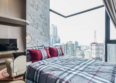 Bedroom with large window and city view