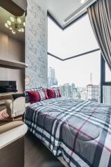 Bedroom with large window and city view