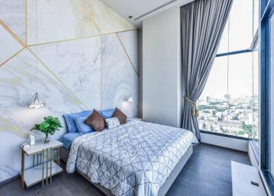 Modern bedroom with large window and city view