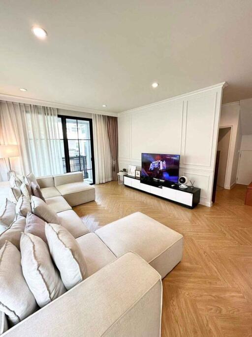 Spacious living room with modern furniture and entertainment center