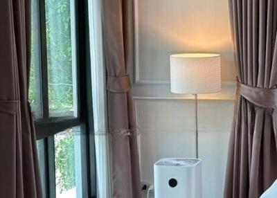 Bedroom corner with air purifier and lamp