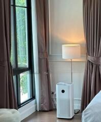 Bedroom corner with air purifier and lamp