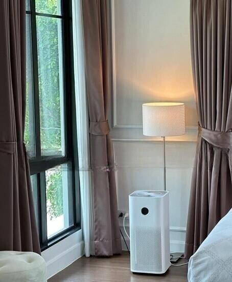 Bedroom corner with air purifier and lamp