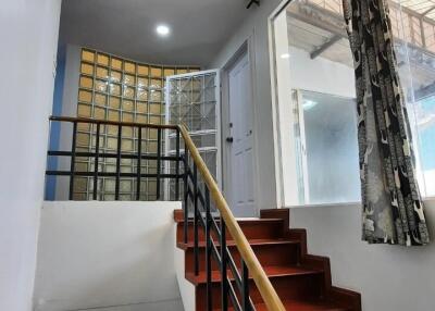 Indoor staircase with wooden steps and a modern railing