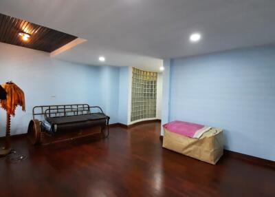 Simple bedroom with wooden flooring and furniture